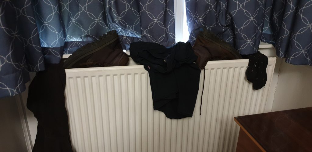 Clothes and shoes on a radiator.