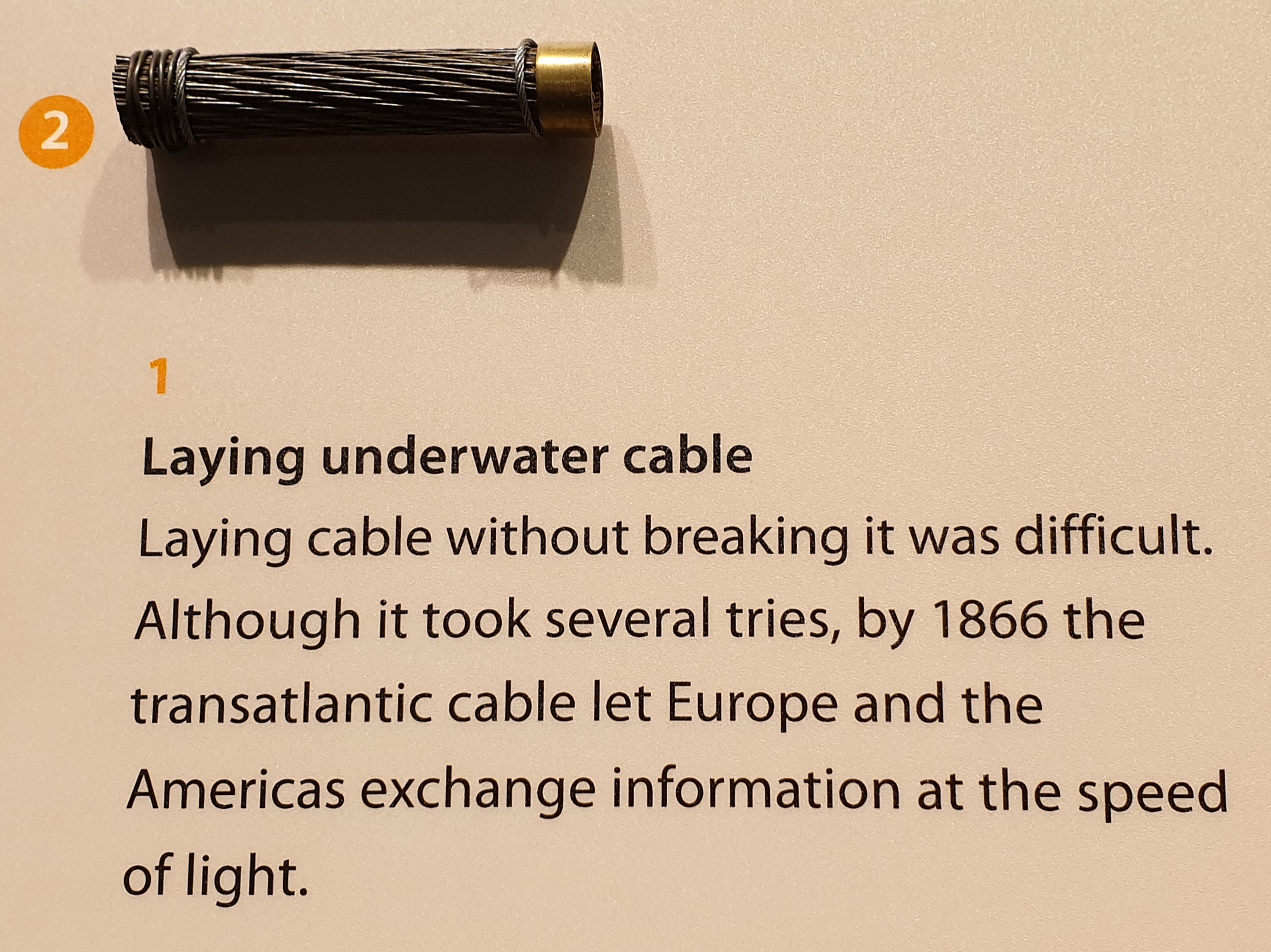 Exhibit of early transatlantic telegraph cable with message implying that it enabled "speed of light" communications.