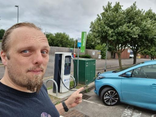 Dan points to his car, plugged in to a charger.