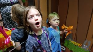 Kids in a decorated elevator.