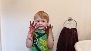 Boy with painted brown hands.