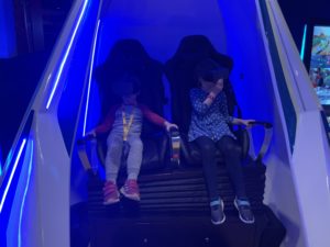 Children in a VR motion simulator.