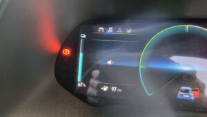 Electric car dashboard with a battery indicator showing 67%