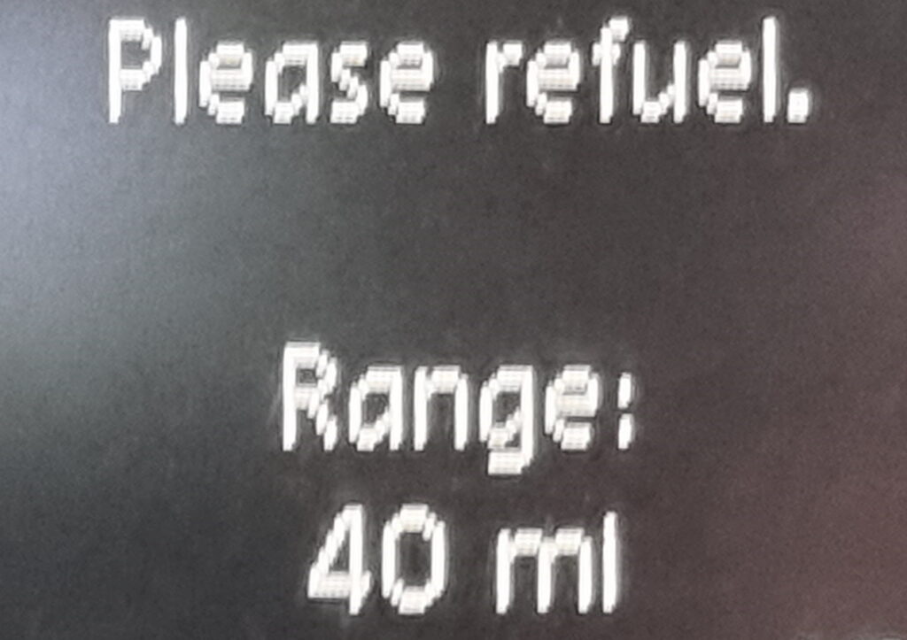 Car display showing "Please refuel. Range: 40ml"