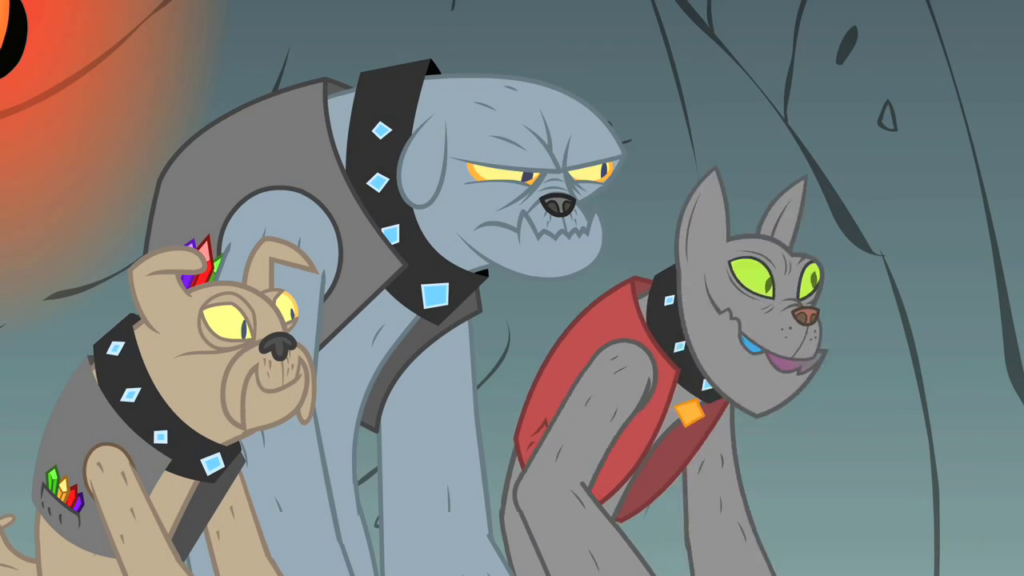 The Diamond Dogs, from My Little Pony: Friendship is Magic season 1, episode 19. A cartoon image shows three humanoid doglike creatures with gem-encrusted collars and gemstones in their pockets. They're facing off-screen, to the right.
