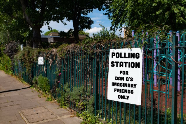 Sign on the fence of a school playground reading, in block capitals: "Polling station for Dan Q's imaginary friends only".