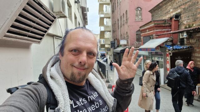 Dan waves from a narrow but busy Istanbul city street.